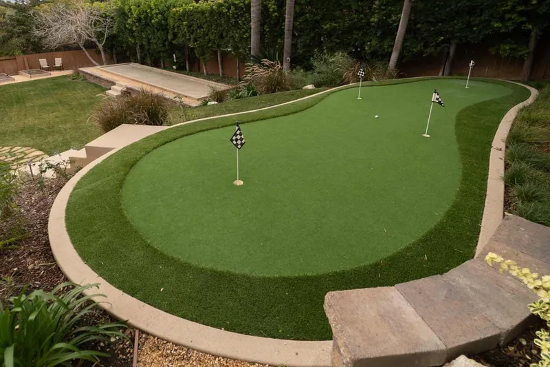 Backyard putting green and pool deck