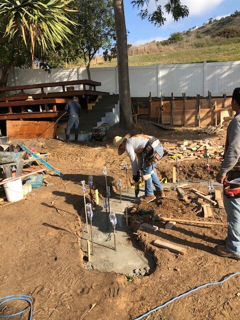 Roy's crew setting forms and steel for a built-in seating footing