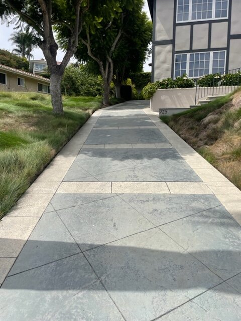 Long hillside concrete driveway with scored banding