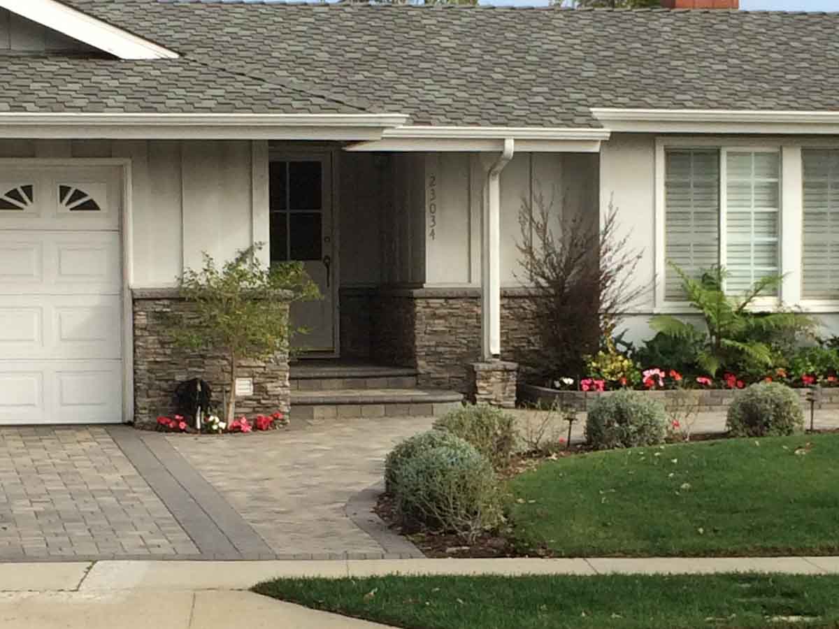 Paver driveway with a stone-faced front entry