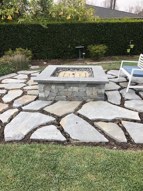 Flagstone patio with a built-in fire pit