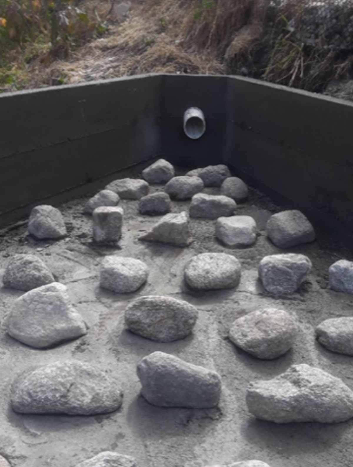 Close view of grouted rock energy dissipater in a drainage structure
